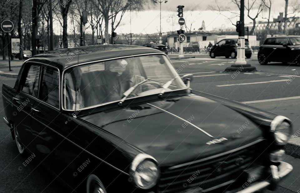 Voiture ancienne dans une rue, chauffeur au volant